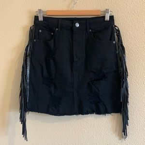 Black denim skirt with leather tassel on the side